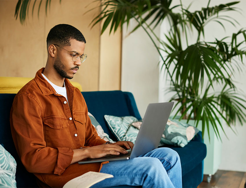 Man sitting on couch on laptop