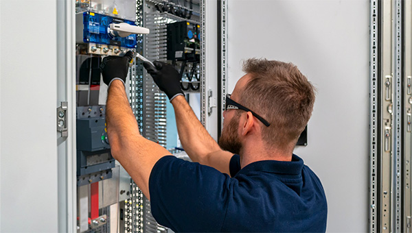 Man fixing electric pannel