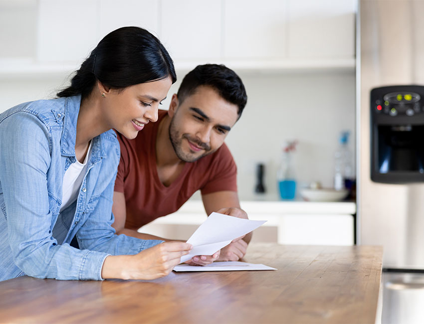 Couple reviewing papers on counter