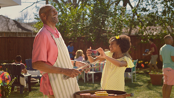 Grandfather and granddaughters by pool