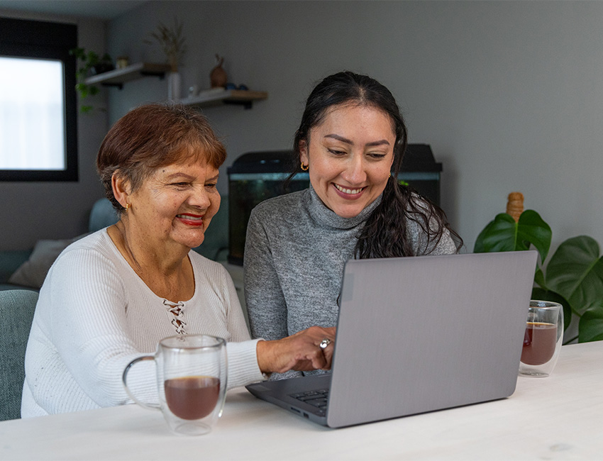 Mother daughter browsing laptop
