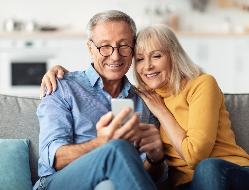 Happy couple checking phone