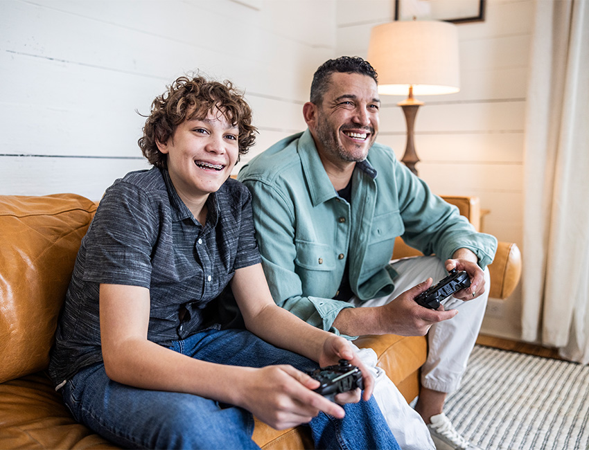 Father son gaming on couch