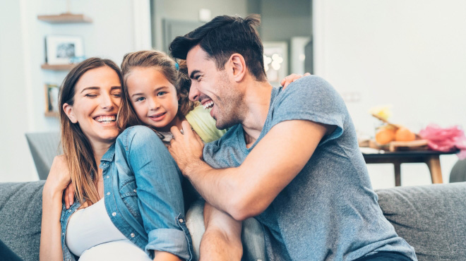 Family smiling on couch
