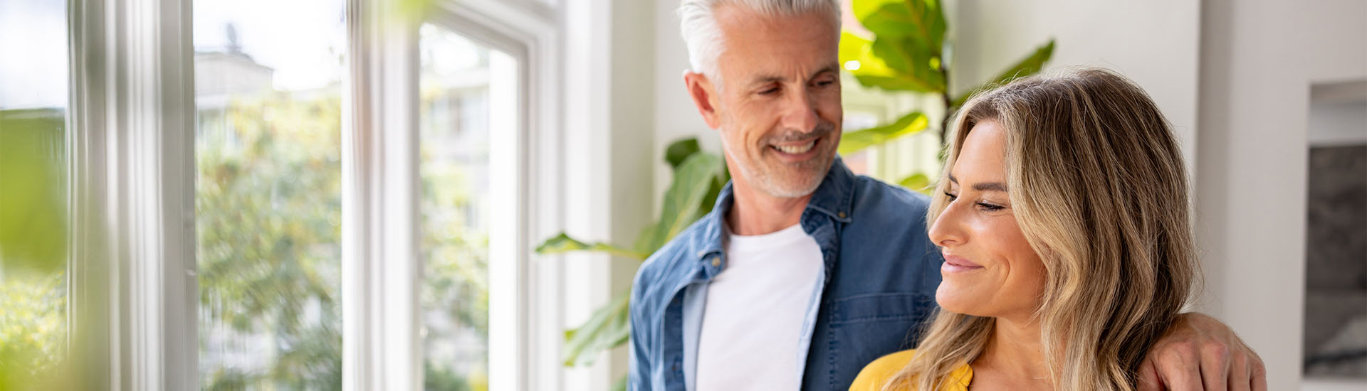 happy couple looking out window