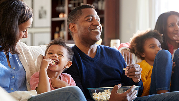 Happy family couch popcorn