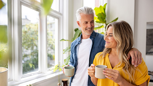 Happy couple looking out window coffee
