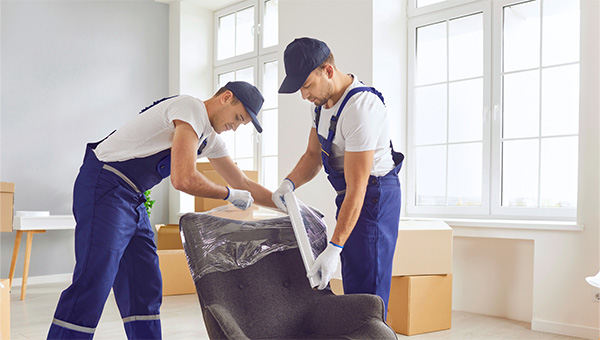 Two men moving boxes