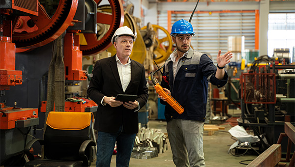 Men standing working hard hats
