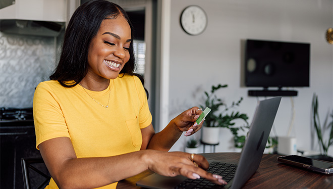 Lady typing on laptop smiling