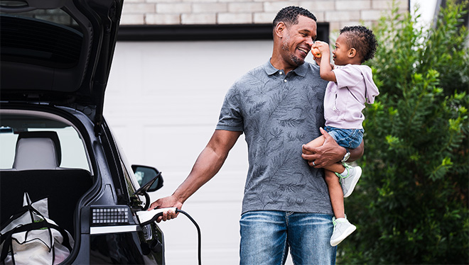 Father and child charging ev