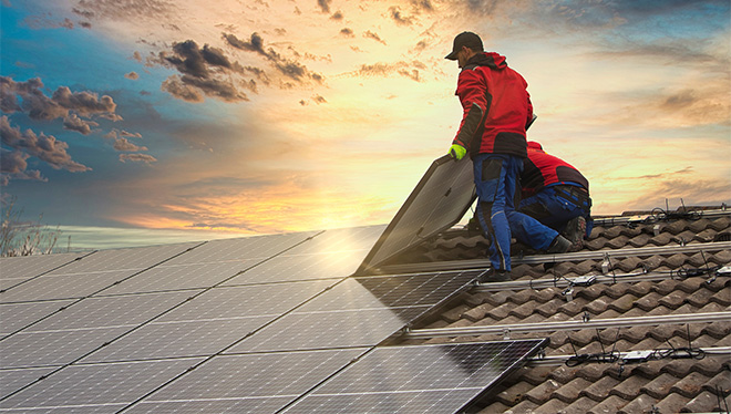men working on rooftop solar panels