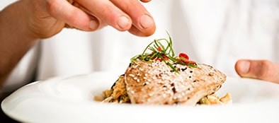 a chef garnishing a dish