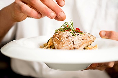 a chef garnishing a dish
