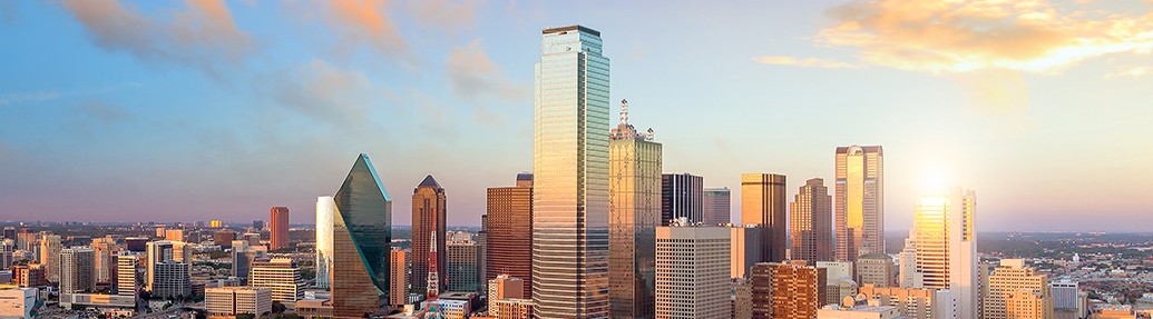 view of a dallas skyline at sunrise 
