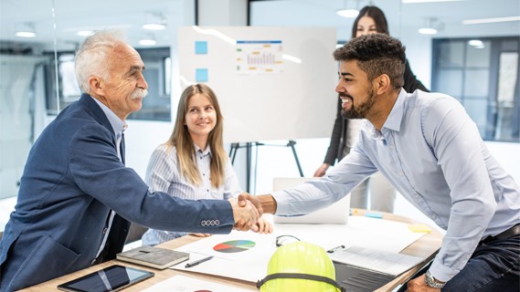 Team shaking hands in office