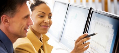 Man and woman looking at computer screen smiling
