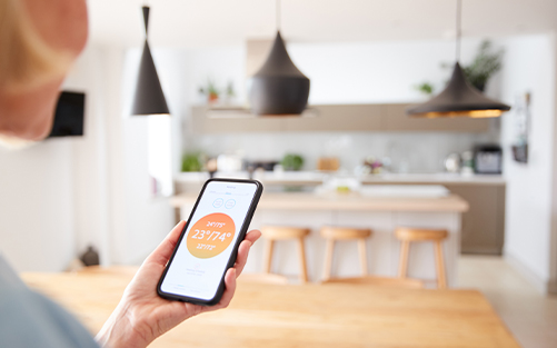 Woman controlling home light with mobile phone